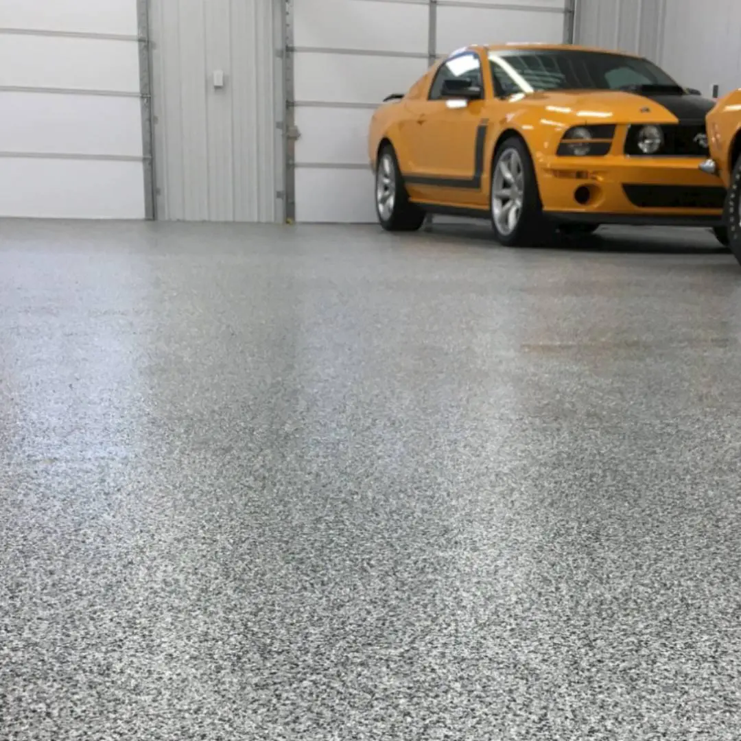 A yellow car parked in the garage next to two white doors.