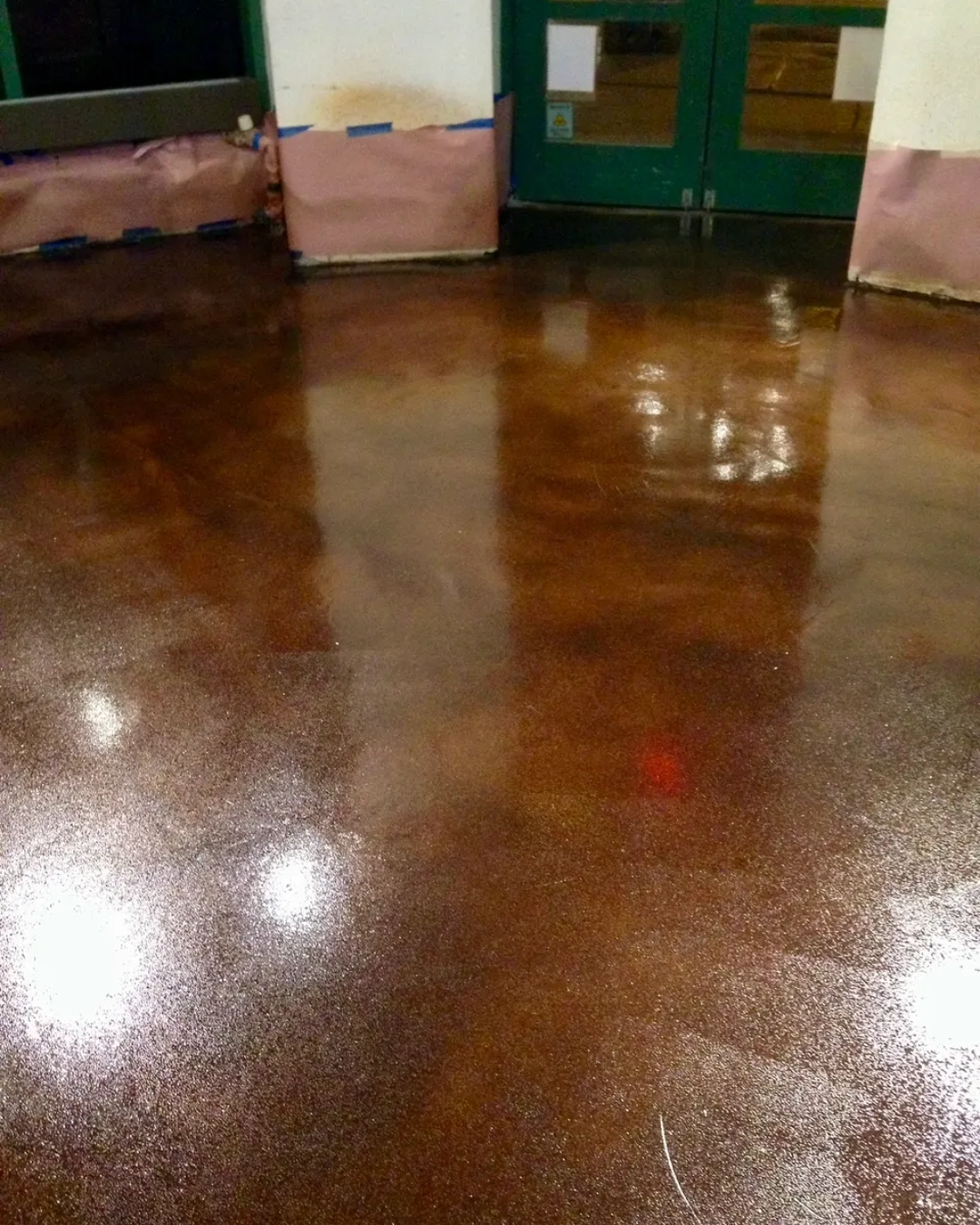 A brown floor with boxes in the background.